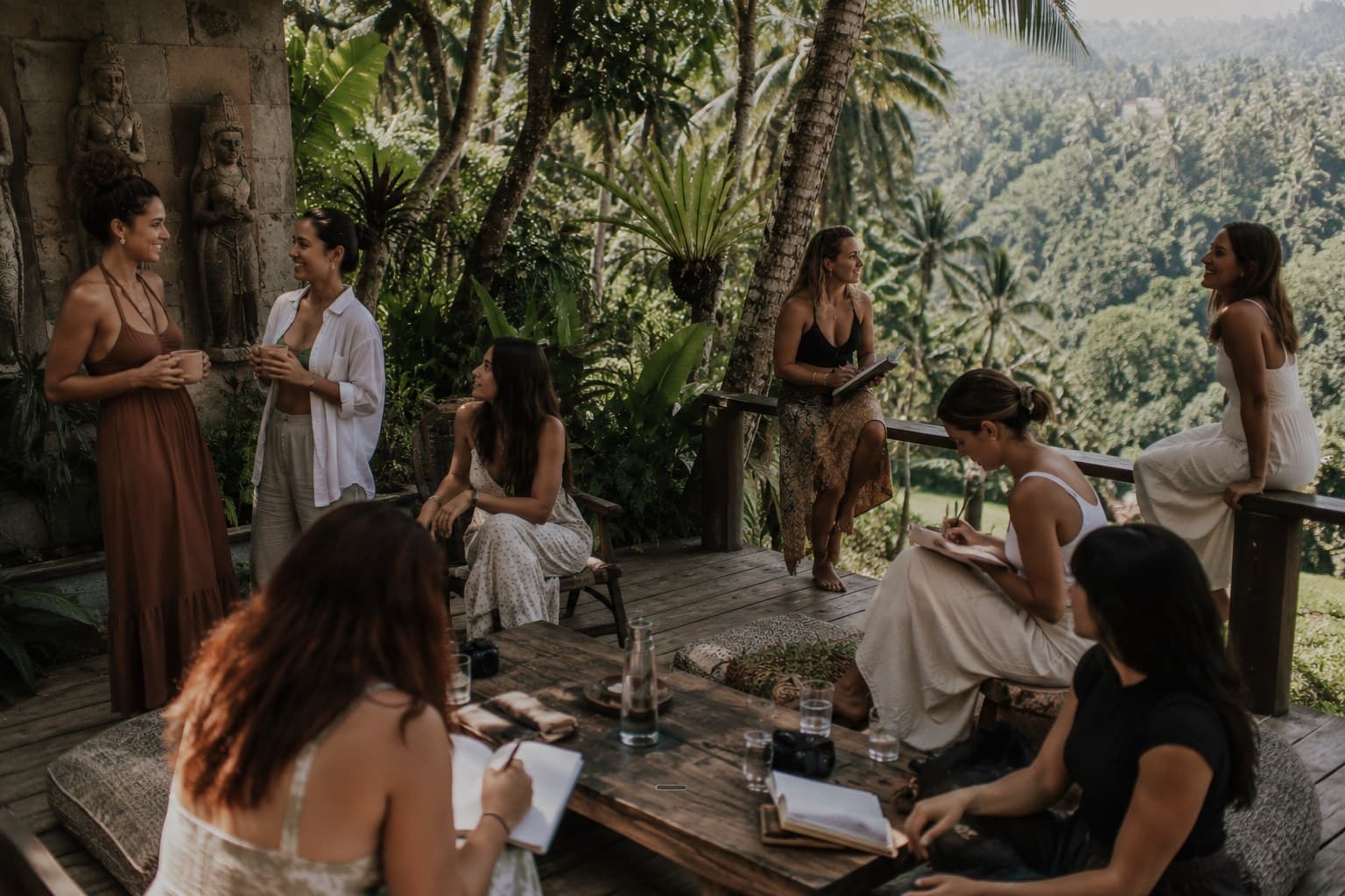 Women gathered on a jungle deck above the Bali rainforest, a Body & Soul wellness retreat.