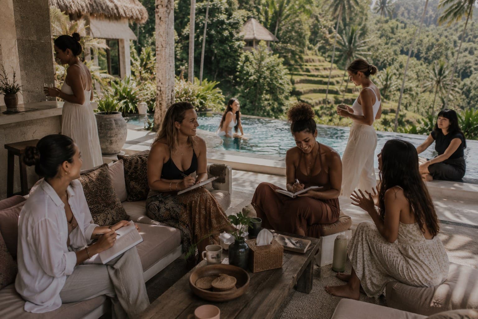 Women gathered by the pool at a Bali villa, a Body & Soul wellness retreat.