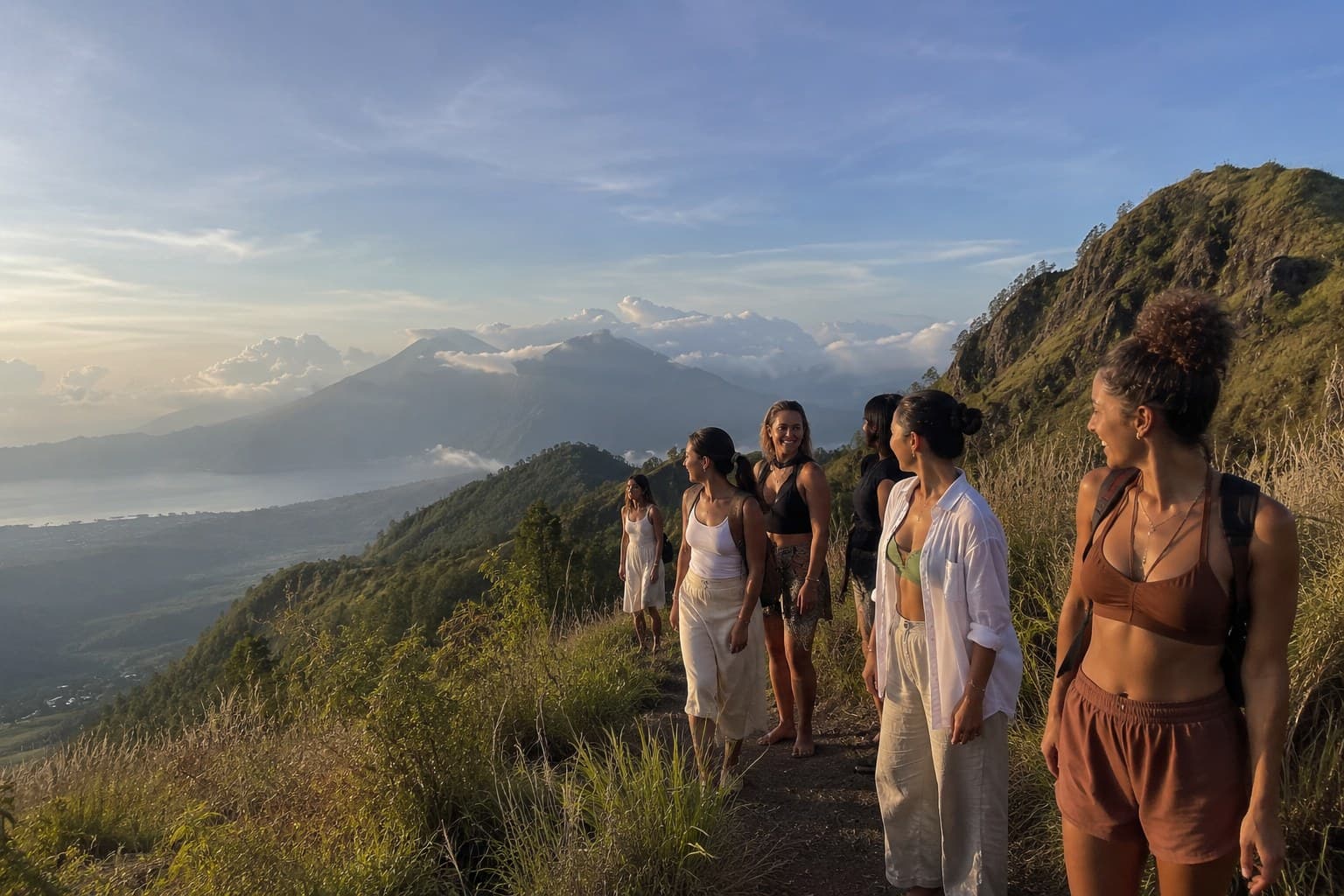 Women hiking a Bali ridge at sunrise, a Body & Soul wellness retreat.